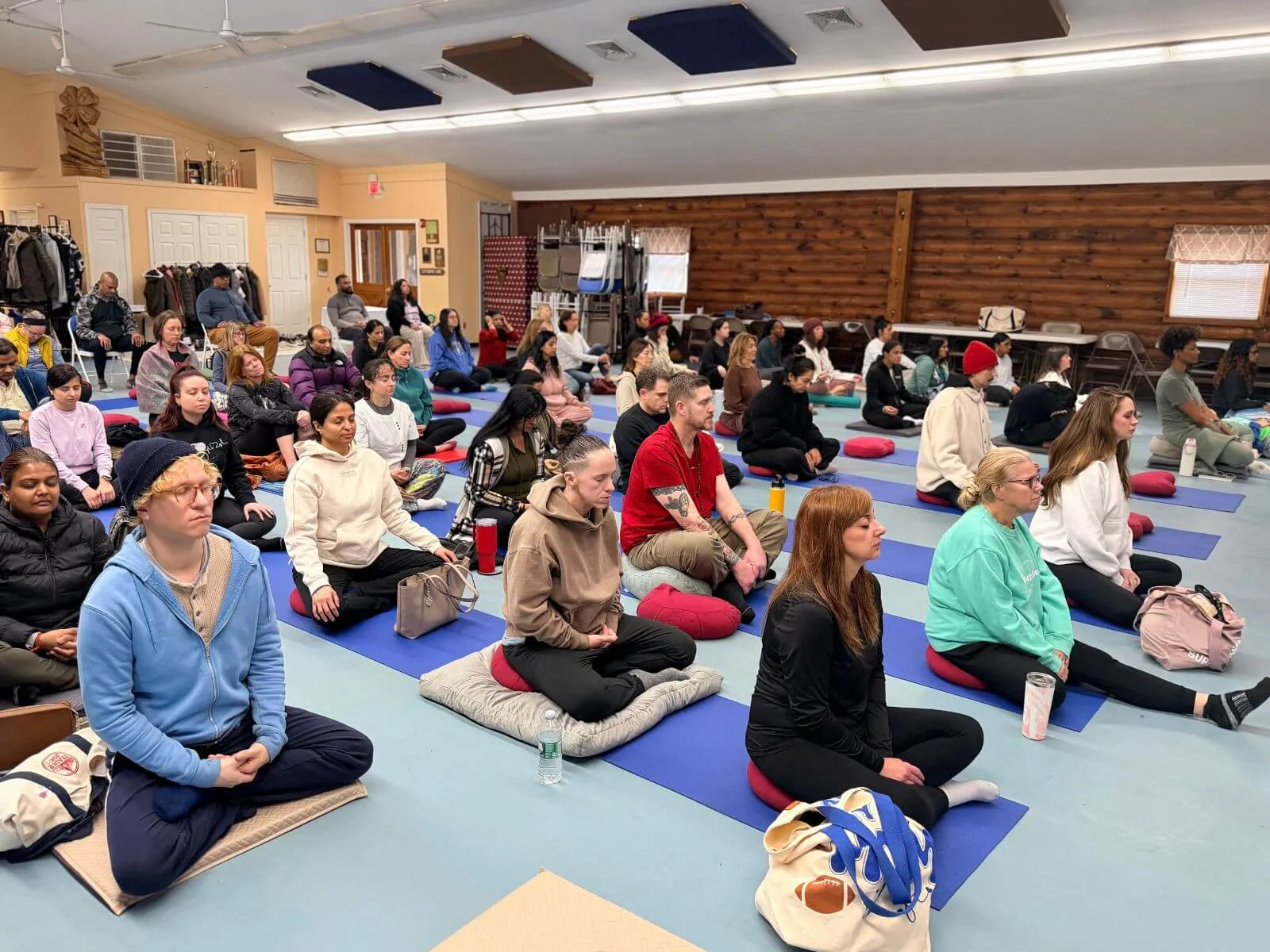 A large group practising loving-kindness meditation at the East Brunswick meditation retreat