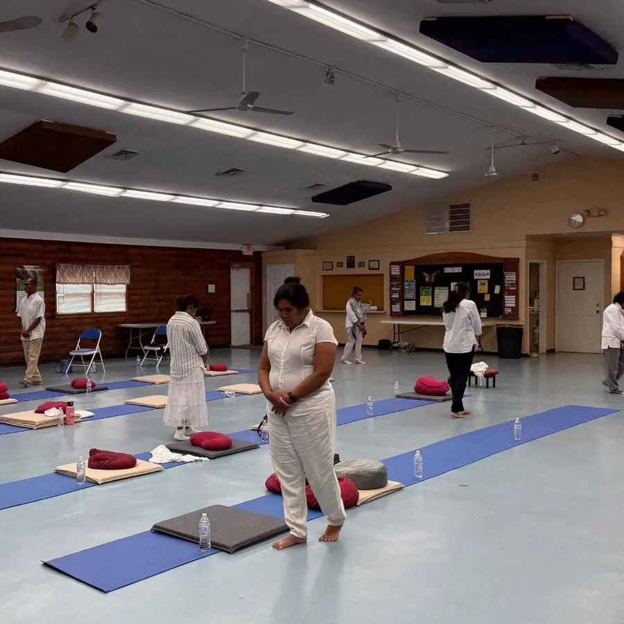 Participants practising walking meditation in the hall at the East Brunswick retreat